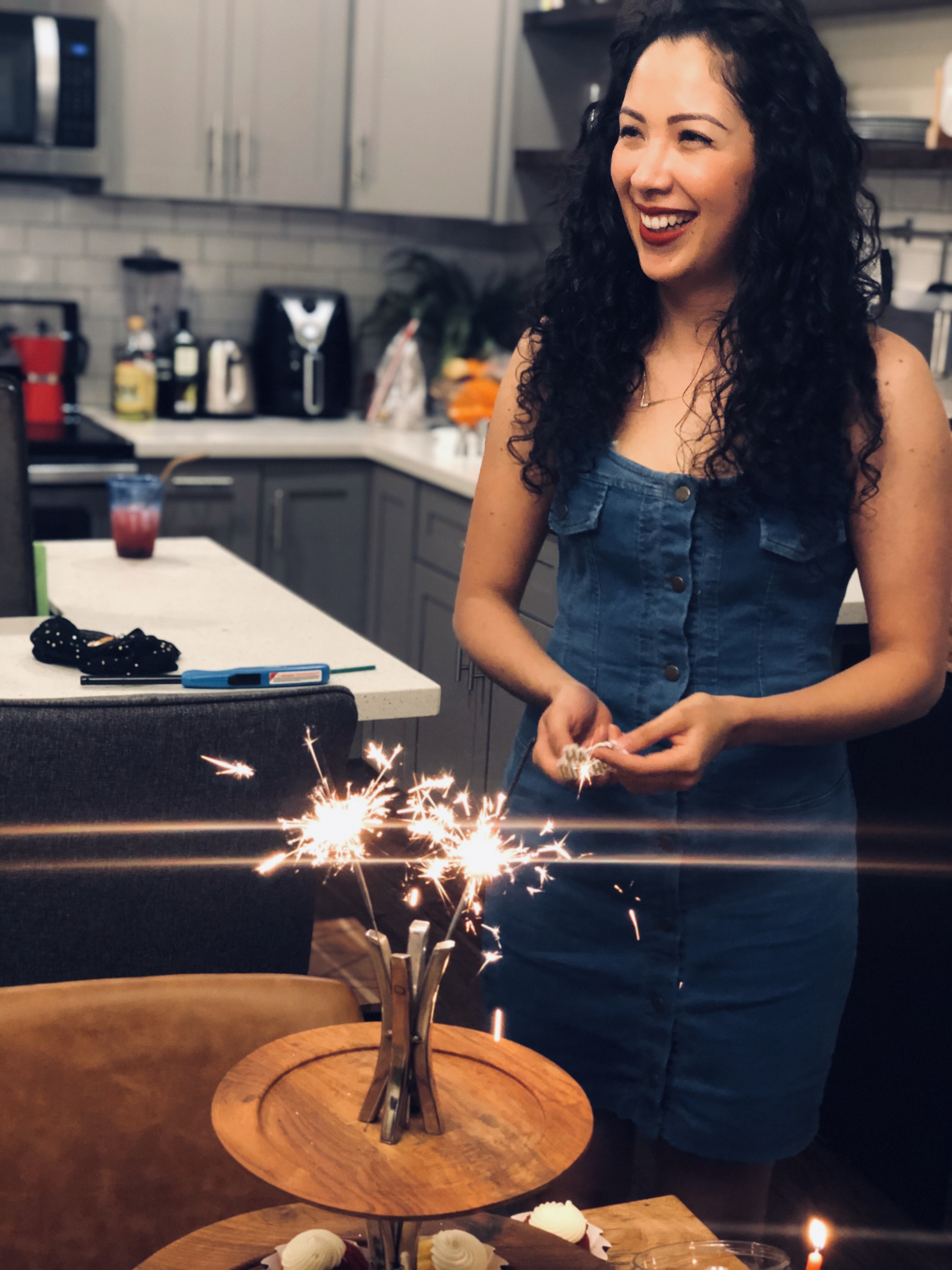 picture of hispanic girl with curly hair holding a small yorkshire terrier dog